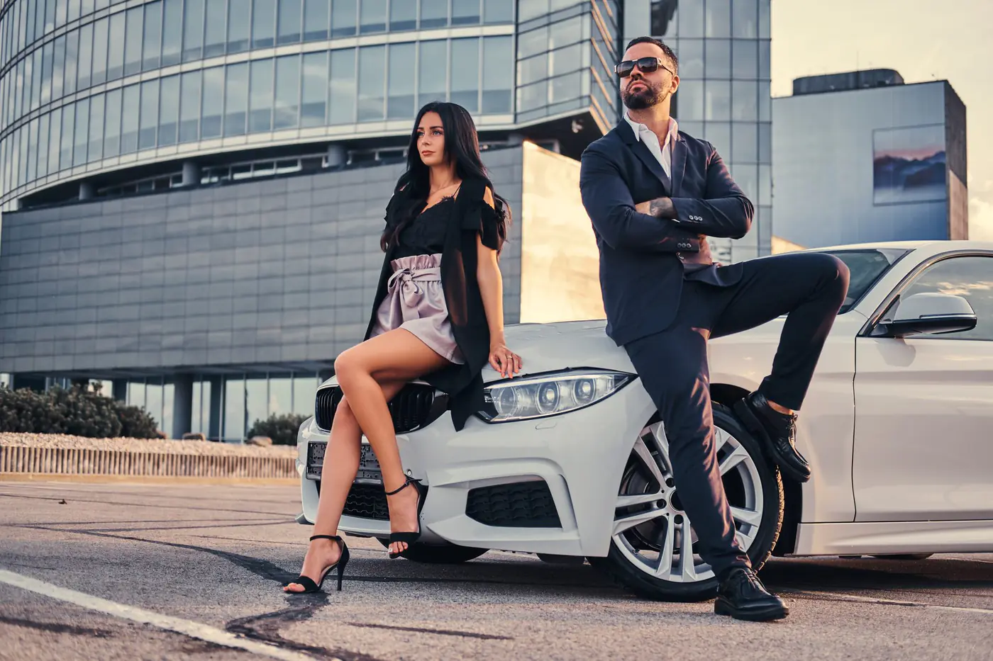 Two well-dressed professionals in a city setting